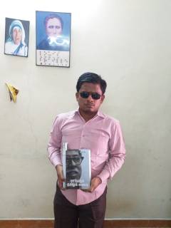 graphic மாபெரும் தமிழ்க்கனவு நூலைக் கையில் ஏந்தியபடி ப. சரவணமணிகண்டன்